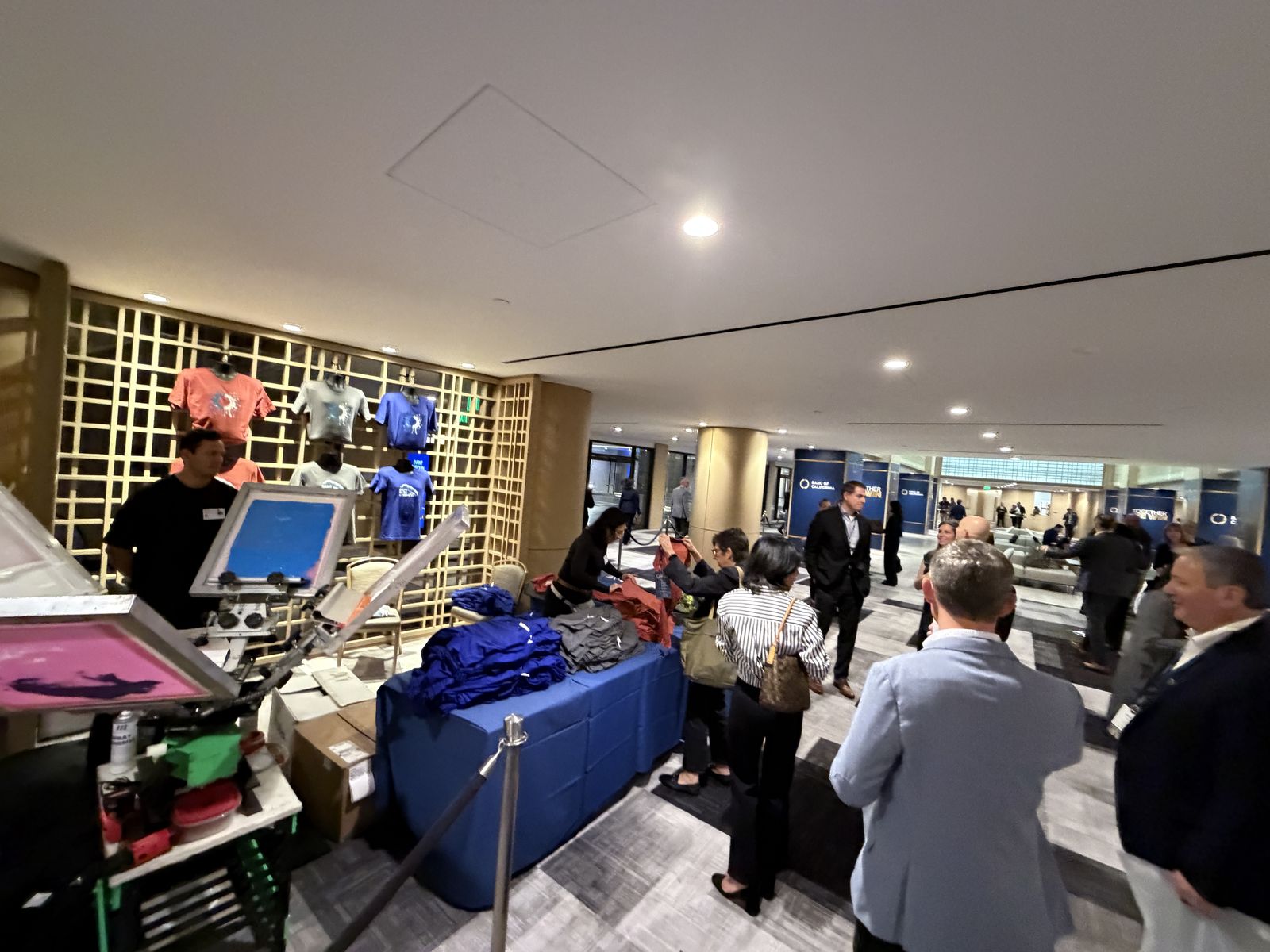 Guests gathering around a branded monogram station in a hotel ballroom foyer